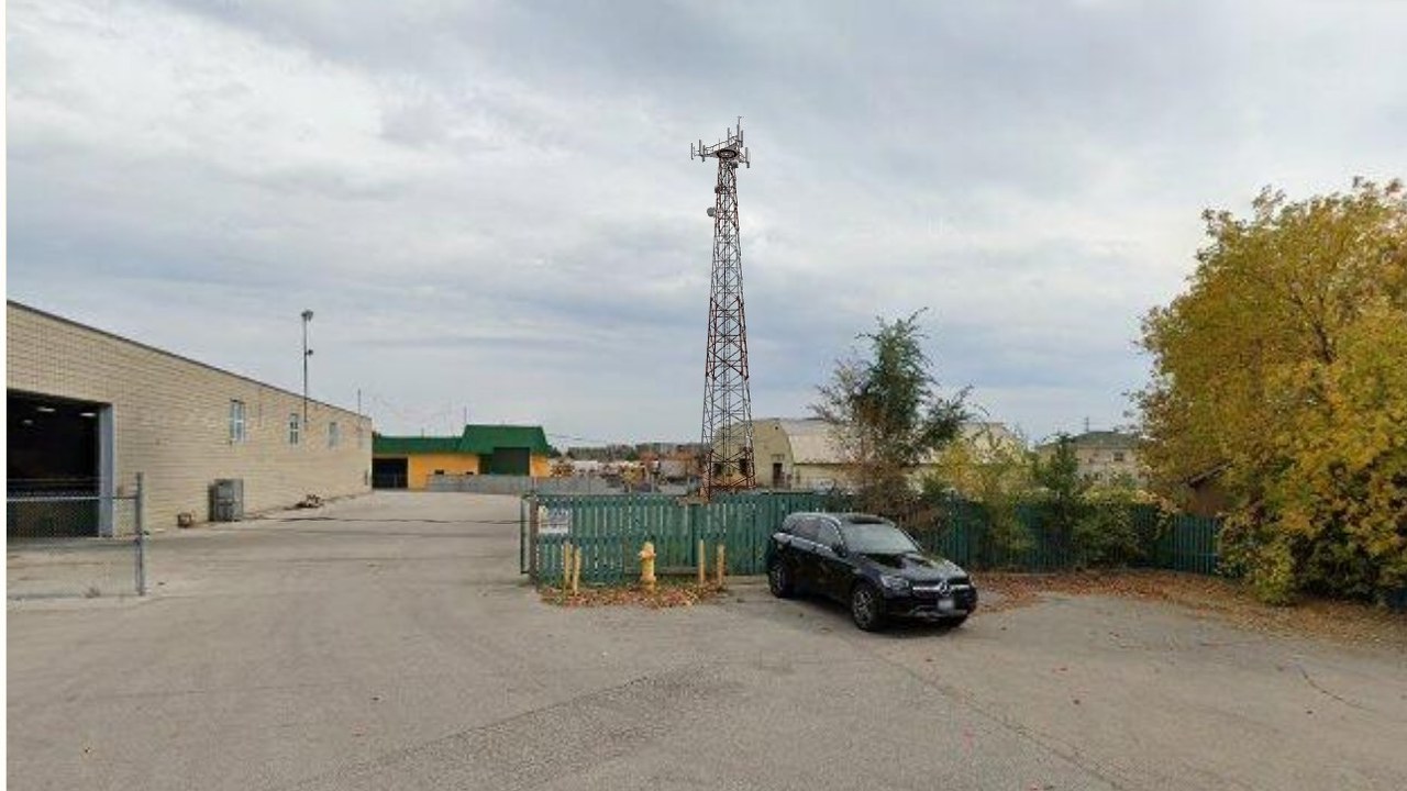 After — a proposed 40 m lattice tower rendered to scale on the real site photo.